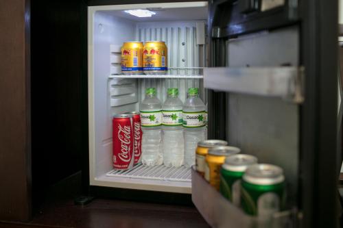 an open refrigerator filled with drinks and soda at Serene Boutique Hotel & Spa in Hanoi
