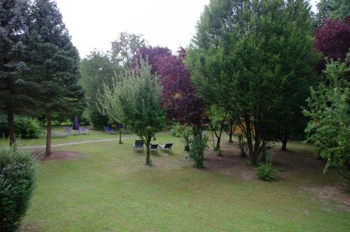 a park with trees and benches in the grass at Sonnleiten-Rupert in Bad Griesbach