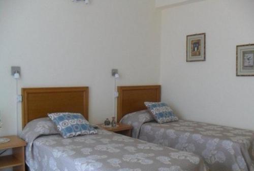 a hotel room with two beds in a room at Hotel Casino Fortunata in Federación