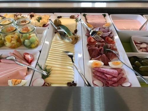 a tray of different types of meats and cheese at DIE KRONE - Hotel Garni in Kirchzarten