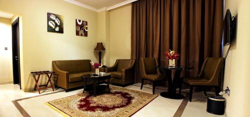 a waiting room with chairs and a table in a hospital at Paragon Hotel Apartments in Abu Dhabi