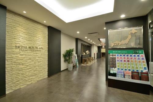 a lobby of a hotel with a sign on the wall at Hotel Route-Inn Yanagawa Ekimae in Yanagawa