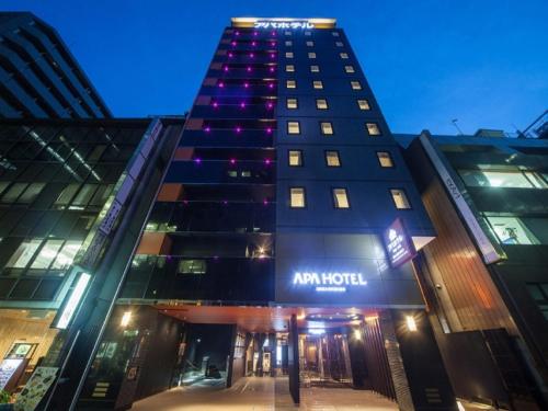a tall building with an am hotel sign on it at APA Hotel Ginza Kyobashi Tokyo-Eki Yaesu Minami-guchi in Tokyo