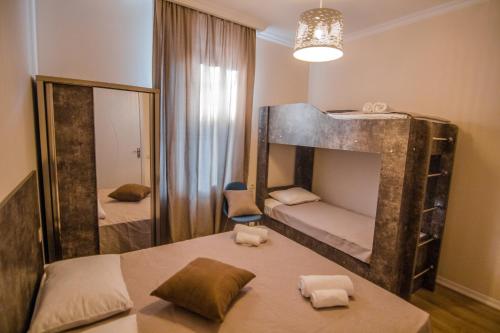 a small room with two bunk beds and a mirror at Boutique Hotel BelleVue in Sighnaghi