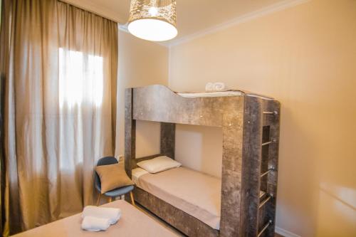 a small room with a bunk bed and a chair at Boutique Hotel BelleVue in Sighnaghi