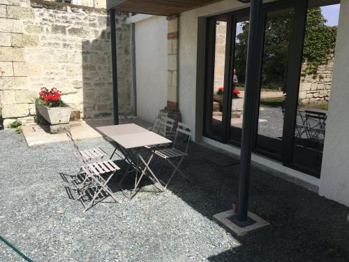 a table and chairs sitting outside of a building at Les Terrasses De Chaumont 1 in Montsoreau