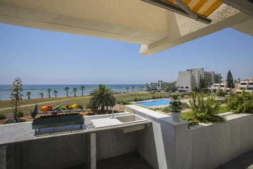 a balcony with a sink and a view of the ocean at Larnaca Sunshore Beachfront Suite in Voroklini