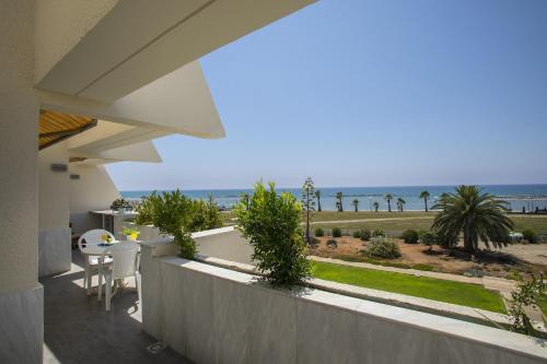 a balcony of a house with a view of the ocean at Larnaca Sunshore Beachfront Suite in Voroklini