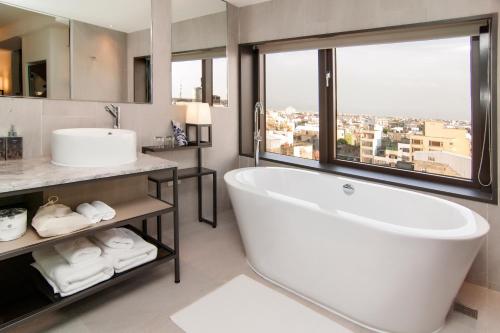 a bathroom with a tub and a sink and a window at UNION HOUSE Lukang in Lukang