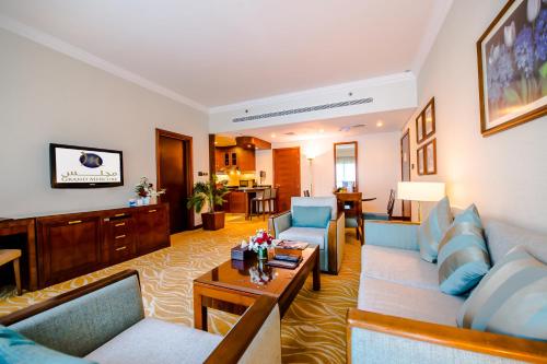 
a living room filled with furniture and a couch at Grand Mercure Abu Dhabi in Abu Dhabi
