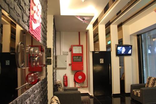 a room with two chairs and a tv in a building at Dream Hotel in Klang
