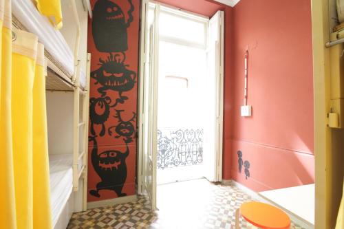 a hallway with a door and a halloween wall at The River Hostel in Valencia