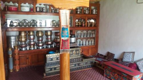 a room with a stand with a lot of dishes at Zee Guest House in Leh