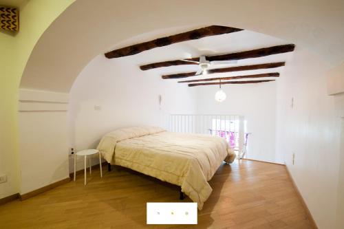 ナポリにあるLovely Holiday Apartmentのベッドルーム1室(ベッド1台付)、梁出し天井