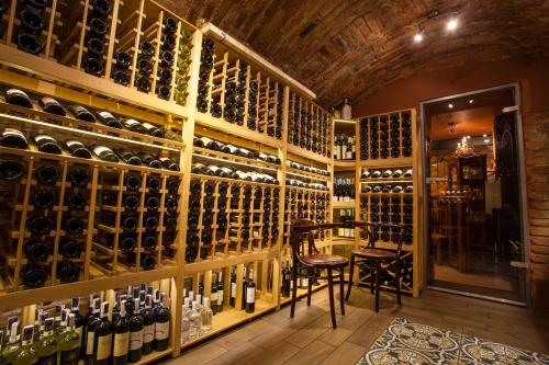 a wine tasting room with a large wall of wine bottles at Aparthotel Oberża in Krakow