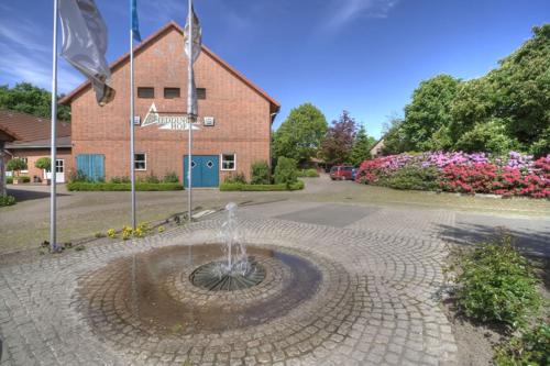 a fountain in the middle of a brick building at Jeddinger Hof Land- und Seminarhotel in Visselhövede