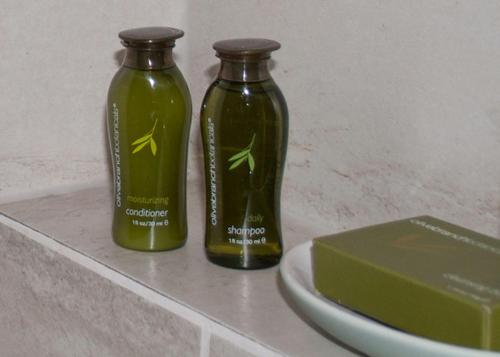 two green bottles sitting on a counter next to a plate at Harbour House Hotel in Ganges