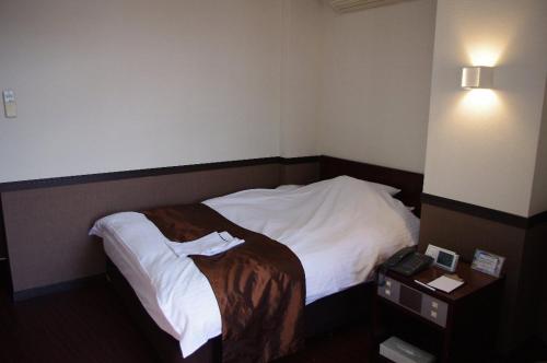 Ένα ή περισσότερα κρεβάτια σε δωμάτιο στο Hotel Saint Paul Nagasaki