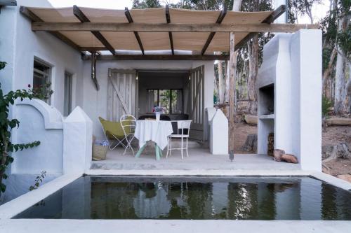 a patio with a table and a pool of water at Kleinkloof Farm in Piketberg