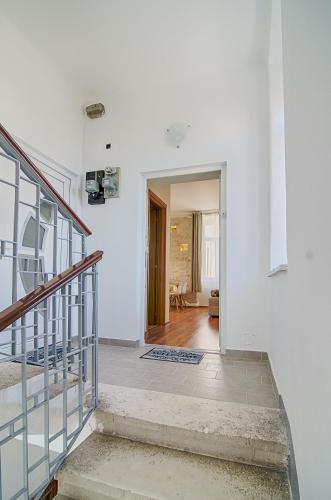 a hallway with a staircase in a white room at Apartment Zora & Natale in Pula
