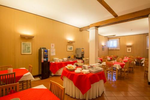 um restaurante com mesas vermelhas e cadeiras num quarto em Casa Sant'Andrea em Veneza