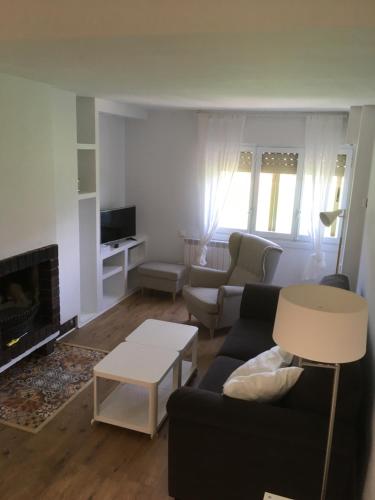 a living room with a couch and a table at Ventana al Pirineo in Jaca