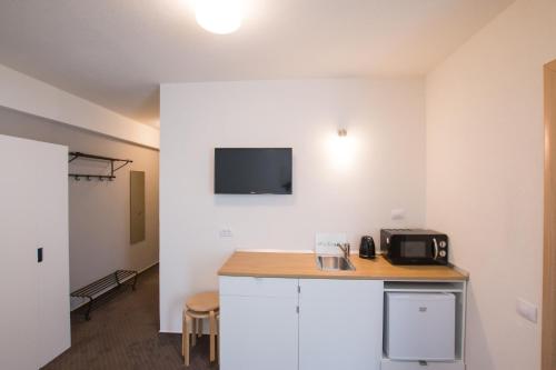 a room with a counter and a tv on the wall at Victoriei City Studios in Bucharest