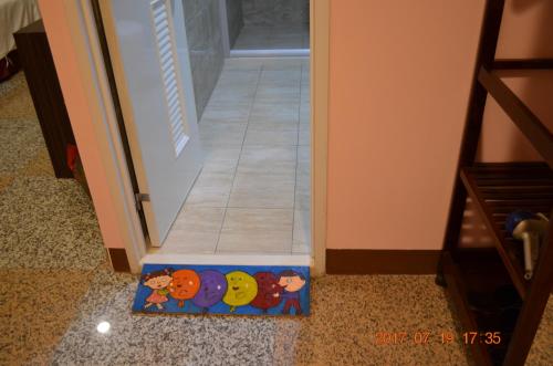 a door mat with cartoon animals on it in front of a door at 台東市安慶67套房館歡迎短租長租 in Taitung City