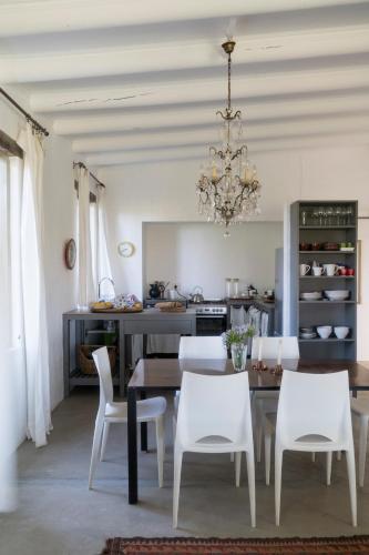 a dining room with a table and chairs and a chandelier at Kleinkloof Farm in Piketberg