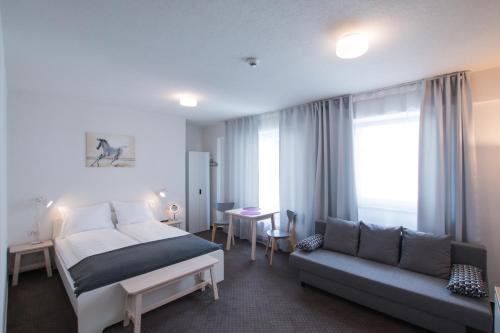 a hotel room with a bed and a couch at Victoriei City Studios in Bucharest