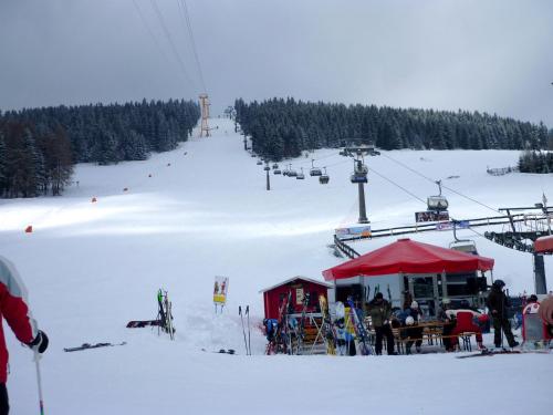 a ski lift with a group of people in the snow at Ferienwohnungen "Am Schlössel" in Kurort Oberwiesenthal