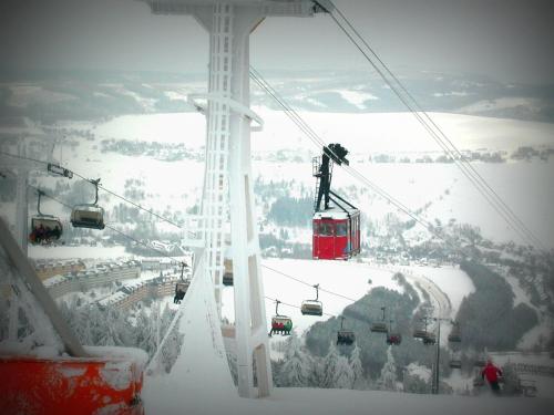 a ski lift in the air in the snow at Ferienwohnungen "Am Schlössel" in Kurort Oberwiesenthal