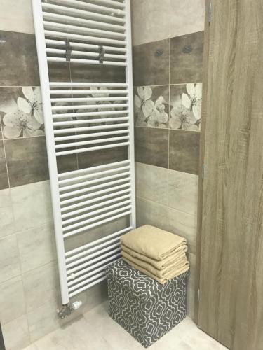 a towel rack in a bathroom with a pile of towels at Apartman illy in Veľký Slavkov