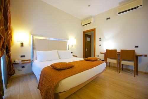 a hotel room with a bed and a table at Best Western Crystal Palace Hotel in Turin