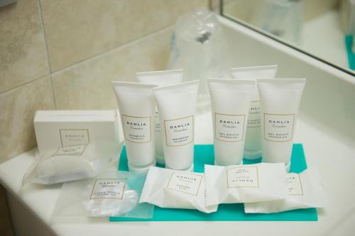 a group of four tubes of sunscreen sitting on a bathroom counter at Best Western Crystal Palace Hotel in Turin