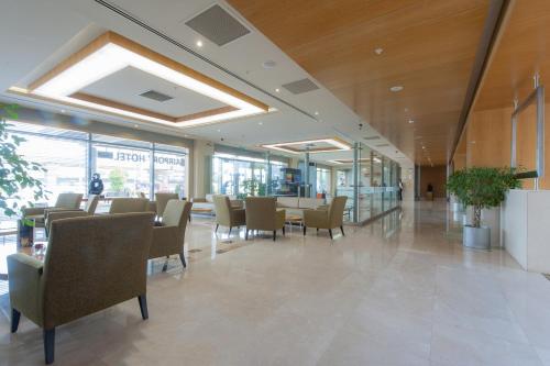 a dining room with chairs and tables in a building at ISG Sabiha Gökçen Airport Hotel in Istanbul