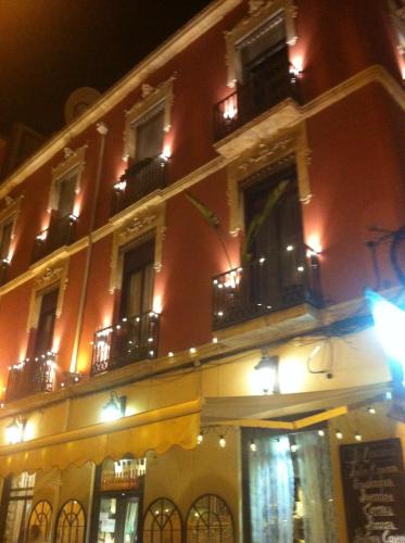 a large building with windows and balconies at night at La dimora del Casanova B&B boutique in Alicante
