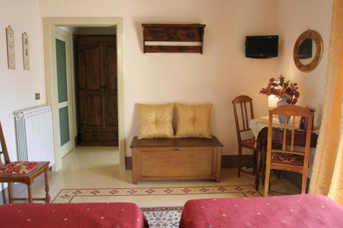 a living room with a couch and a table and chairs at B&B Palazzo Gambino in Acireale