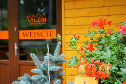a display of flowers in front of a building at Villa Winterpol in Karpacz