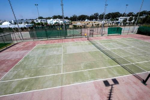 a tennis court with two tennis courts at Medina Belisaire And Thalasso in Hammamet