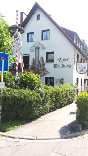 a white building with a sign in front of it at Hotel Landgasthof Wallburg in Eltmann