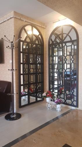 a room with two large windows with flowers in them at Selimiye Palace in Edirne
