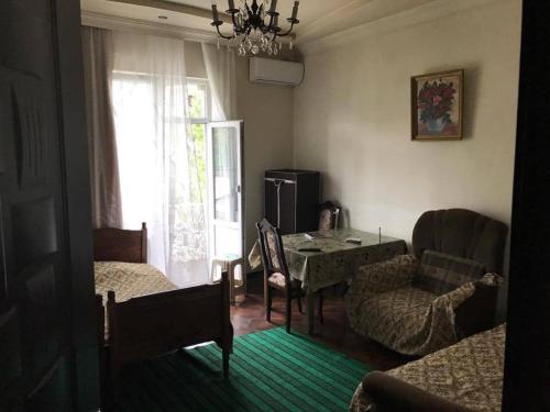 a living room with a table and chairs and a window at Seaside House Kobuleti in K'obulet'i