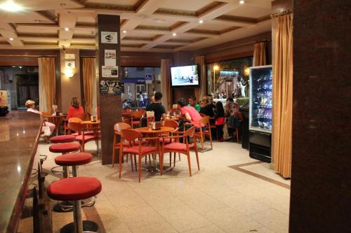 a restaurant with people sitting at tables and chairs at Nueva Colina in Tomiño