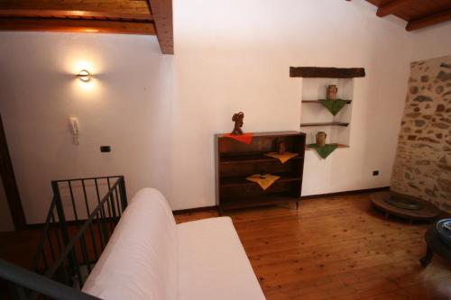 a living room with a couch and a stair case at La corte di Pietro in Isnello