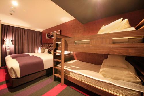 a room with two bunk beds in a hotel at Centurion Hotel&Spa Ueno Station in Tokyo