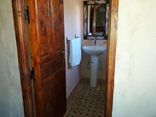 a bathroom with a sink and a mirror at Toubkal Ecolodge in Imlil