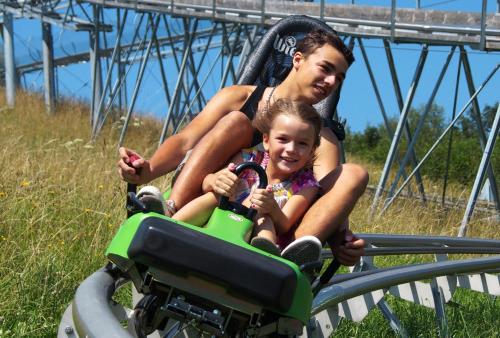 a woman and a child riding on a roller coaster at Hotel Gasthof Mitteregger - BEST PLACE in town with summercard included in Kaprun
