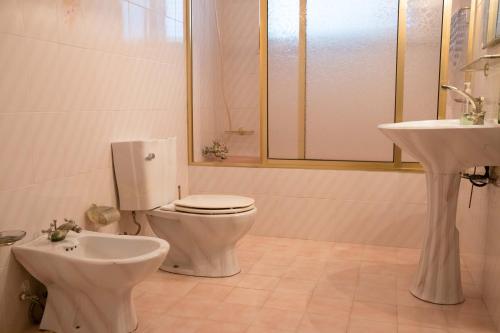 y baño con aseo y lavamanos. en Home Pico - Casa dos Cedros (Alojamento local), en Criação Velha