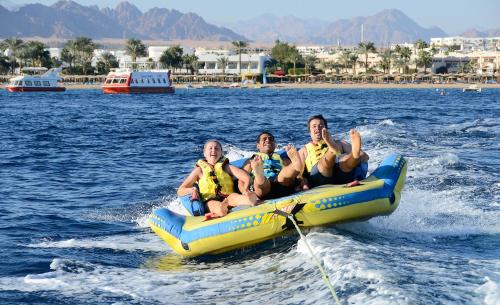 a group of people sitting on a raft in the water at Stella Di Mare Beach Hotel & Spa in Sharm El Sheikh